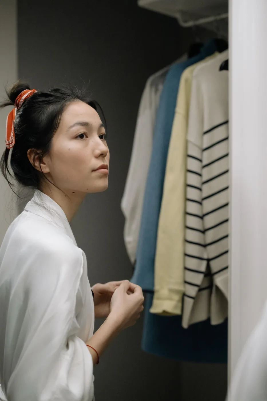 A woman beside a wardrobe door