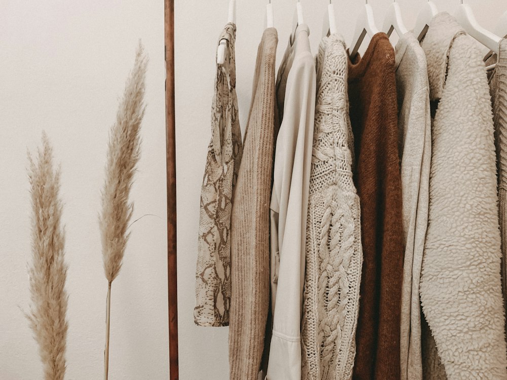 Neutral garments hanging together on a clothes rail